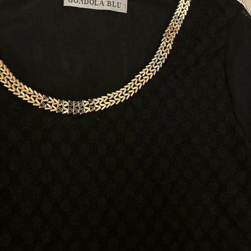 Black blouse used with gold metallic design and mesh sleeves