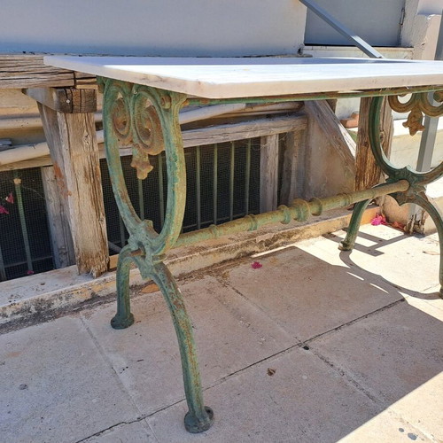 Table with cast iron base and marble used