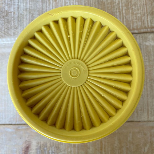 Vintage Tupperware container used yellow with radial lid