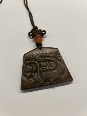 Pendant necklace with carved brown jade dragon, like new