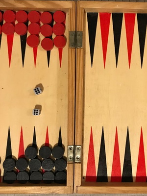 Mini wooden travel backgammon like new with 15 red and 15 black checkers