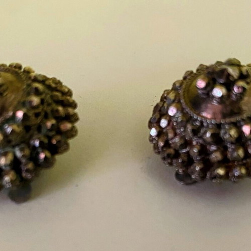 Vintage clip-on earrings with embossed marcasite-style details, used
