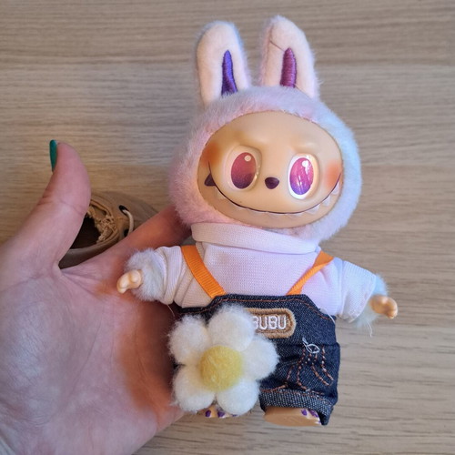 Labubu doll with pastel pink, purple, and blue clothes like new