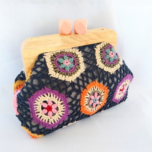 Handmade shoulder bag with knitted floral fabric and wooden clasp