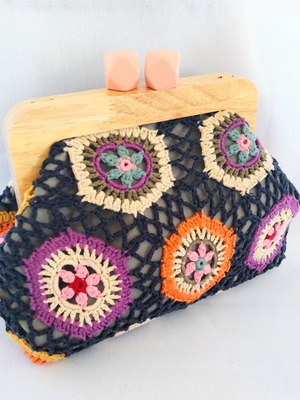 Handmade shoulder bag with knitted floral fabric and wooden clasp