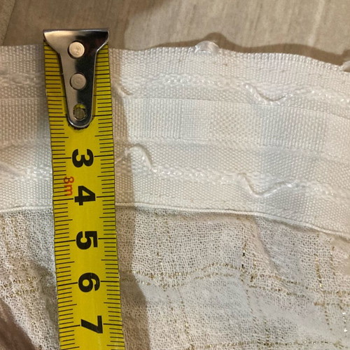 Set of 2 white curtains with gold thread squares and gray rug used