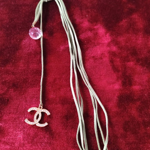 Asymmetric long necklace with green suede cord, crystal & CC motif used