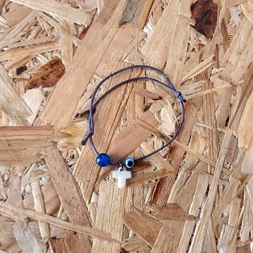 Bracelet with cross charm and evil eye protection