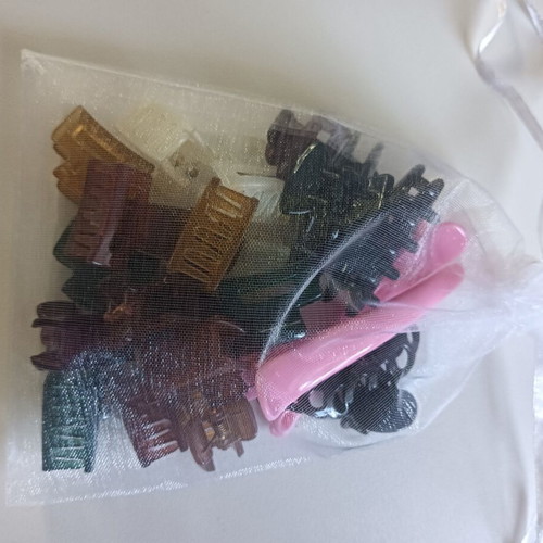 Mini hair clips in various colors and sizes, unused