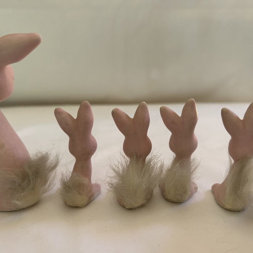 Vintage ceramic pink bunny family figurines with decorative Easter egg