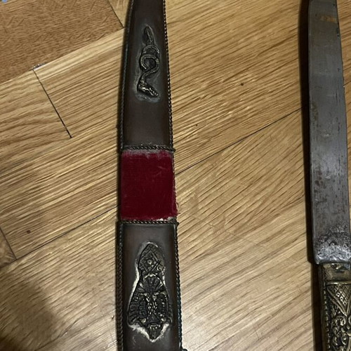 Traditional collectible knife mid-century with carved handle and sheath used