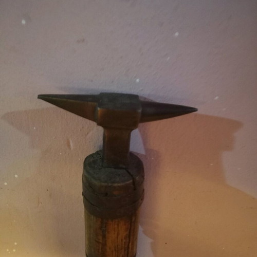 Anvil used for goldsmith or watchmaker with wooden base