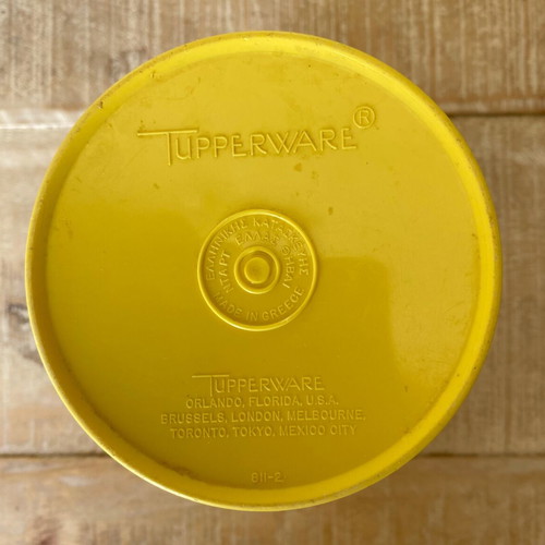 Vintage Tupperware container used yellow with radial lid
