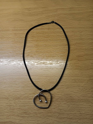 Faux heart-shaped pendant like new, silver with cord