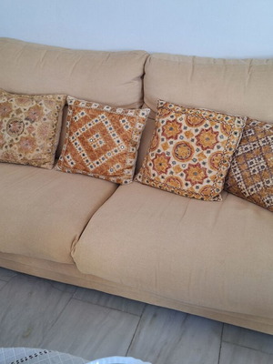 Beige fabric 3-seater sofa with ethnic pattern cushions