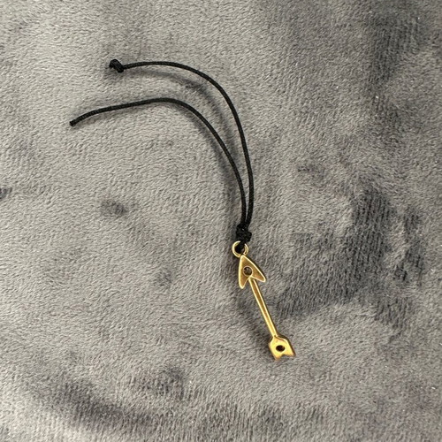 Arrow pendant necklace used with black cord and gold detail