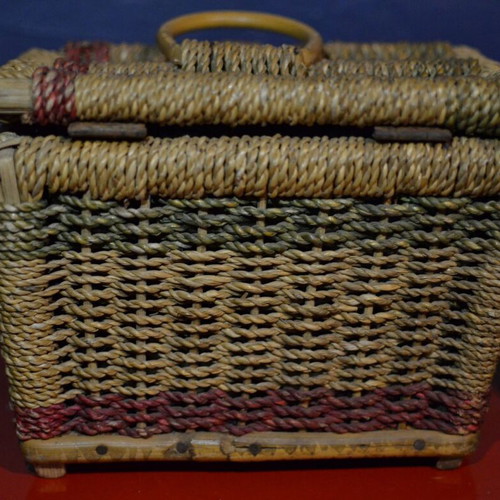 Vintage wicker storage basket used with leather strap and metal clasp