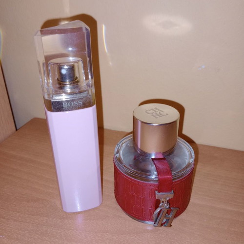 Empty Hugo Boss and Carolina Herrera perfume bottles collectible