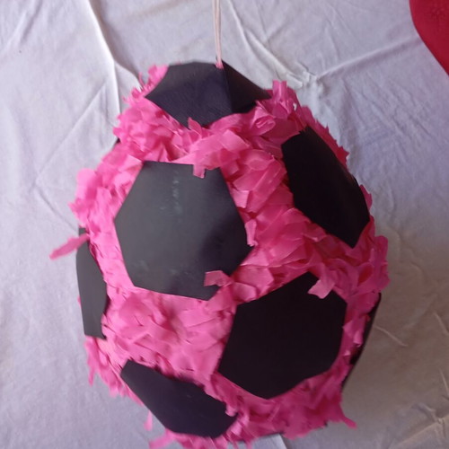 Piñata in the shape of a soccer ball like new, pink and black