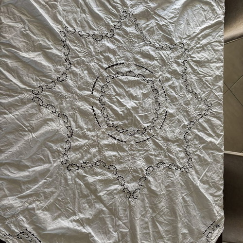 Handmade tablecloth used, cotton fabric with intricate cutwork embroidery
