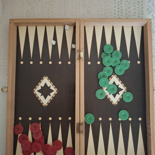 Backgammon and chess board used, missing chess pieces