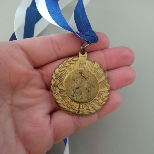 Gold basketball medal like new with blue and white ribbon