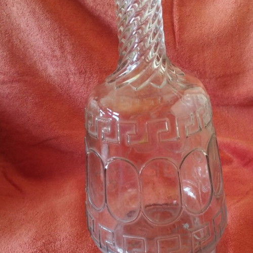 Glass wine carafe used with meander design