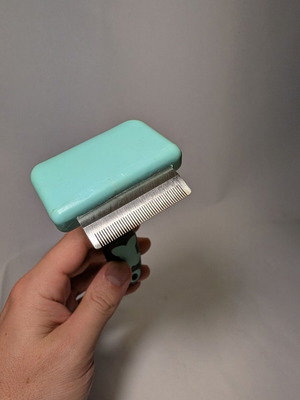 Deshedding grooming brush for dogs and cats used
