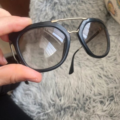 Prada sunglasses in black with gold details