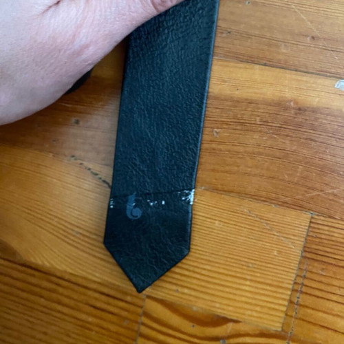 Leather thin black tie vintage used with fading marks