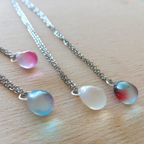 Handmade pendants from iridescent glass and steel
