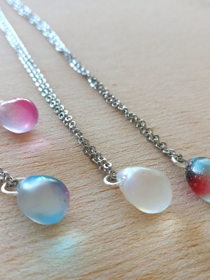 Handmade pendants from iridescent glass and steel
