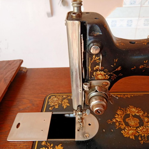 Antique sewing machine used with furniture and accessories