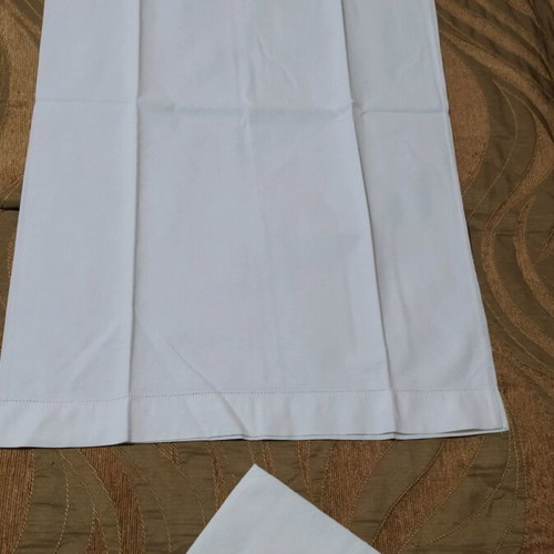 Set of 2 white pillowcases used for sleeping