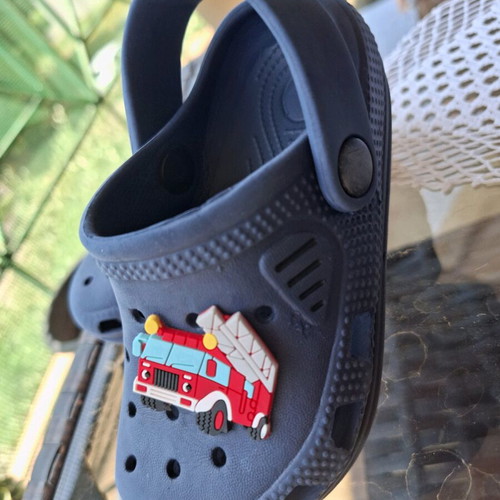 Kids Cros slippers size 25 like new, blue with fire truck figure