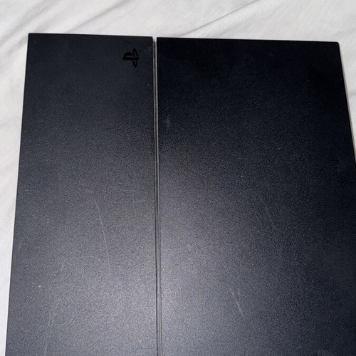 PlayStation 4 console with FIFA 19 and cables