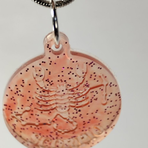 Handmade pendant with zodiac sign Gemini or Scorpio in red pigment