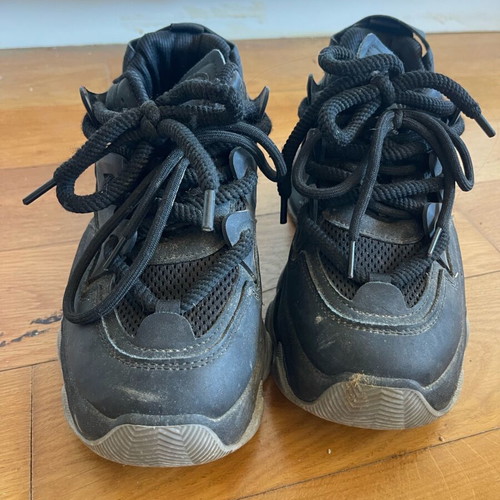 Athletic shoes used with thick sole and laces black with gray