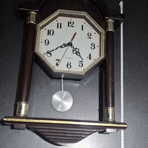 Quartz wall clock with pendulum used, faux wood plastic