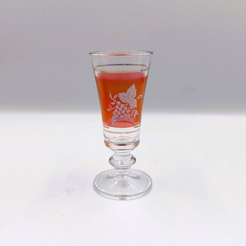 Italian glass decanter with glasses used, red with gold details