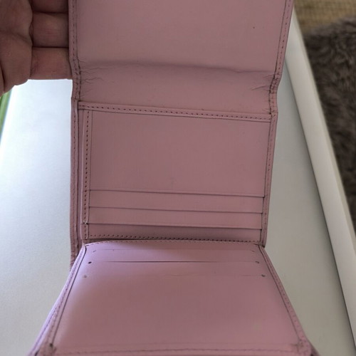 Dior wallet used, pink with slight wear and missing stud