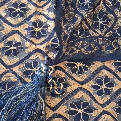 Blue embroidered decorative square used with gold thread