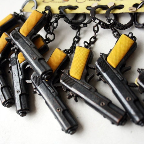 Card with 12 vintage 80's Colt 45 metal pistol keychains new