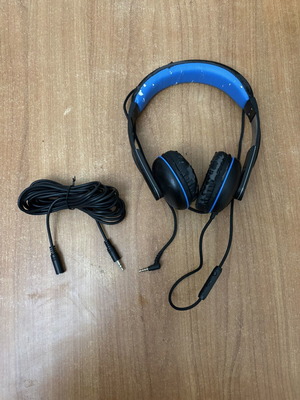 Wired headphones with 5m extension cable used, visible wear on plastic