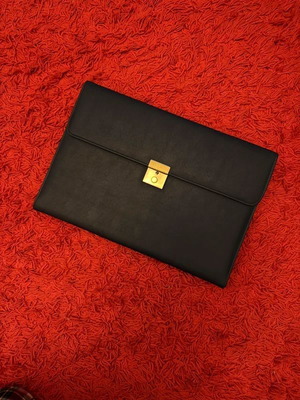 Clutch used, black with gold clasp, leatherette material