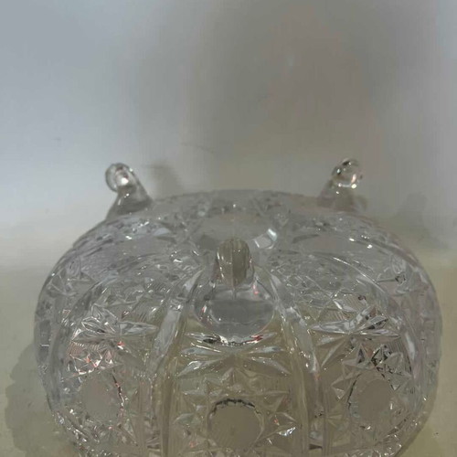 Vintage crystal bowl with feet and embossed carved designs, used