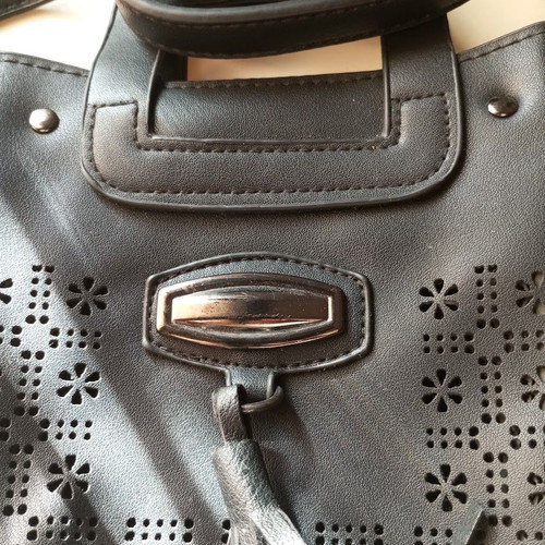 Black Women's Shoulder Bag like new with laser-cut patterns and tassels