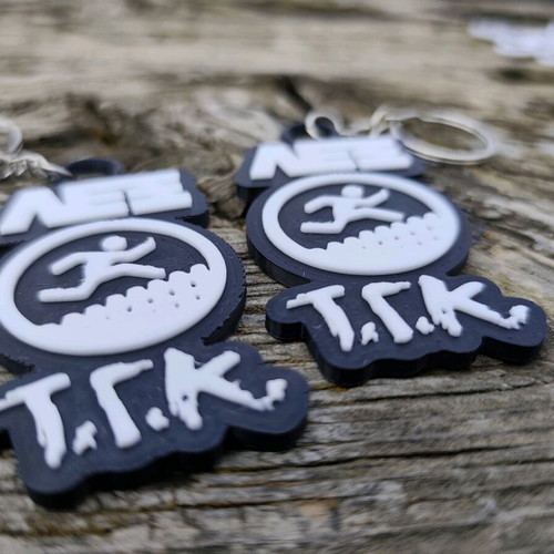 Set of 2 Lex T.G.K. keychains new with embossed design