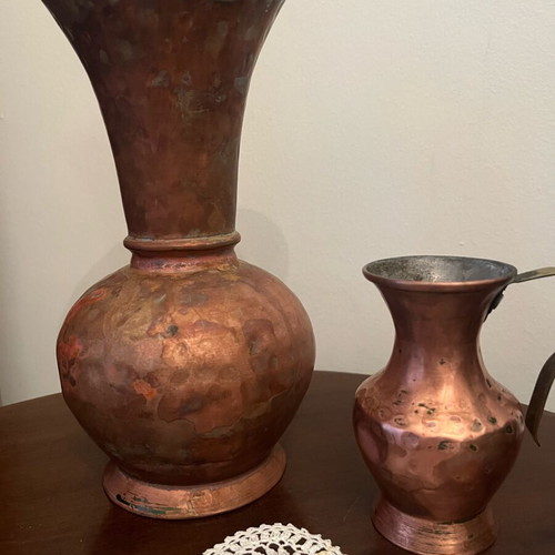 Two decorative hammered copper vases used with natural patina