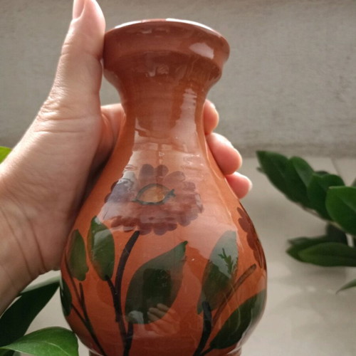Traditional clay vase used, hand-painted with flowers